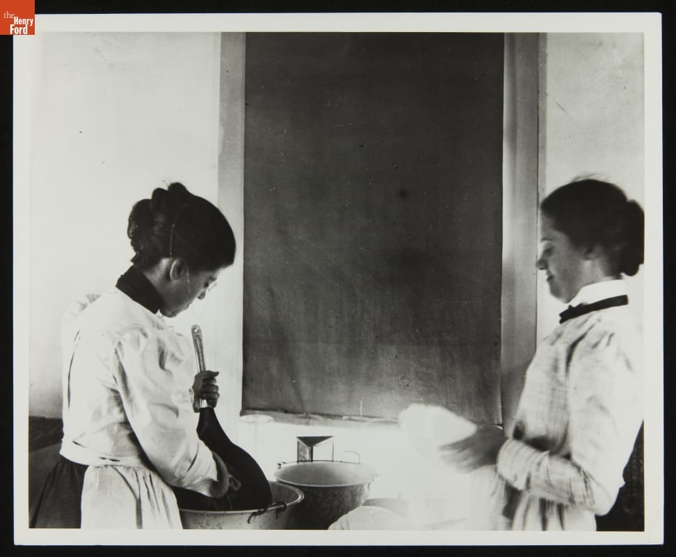 Katharine Wright and Harriet Silliman Washing Dishes, Wright Home, Dayton, Ohio, 1896 Two women wash dishes among tubs of water in front of a window with a closed blind