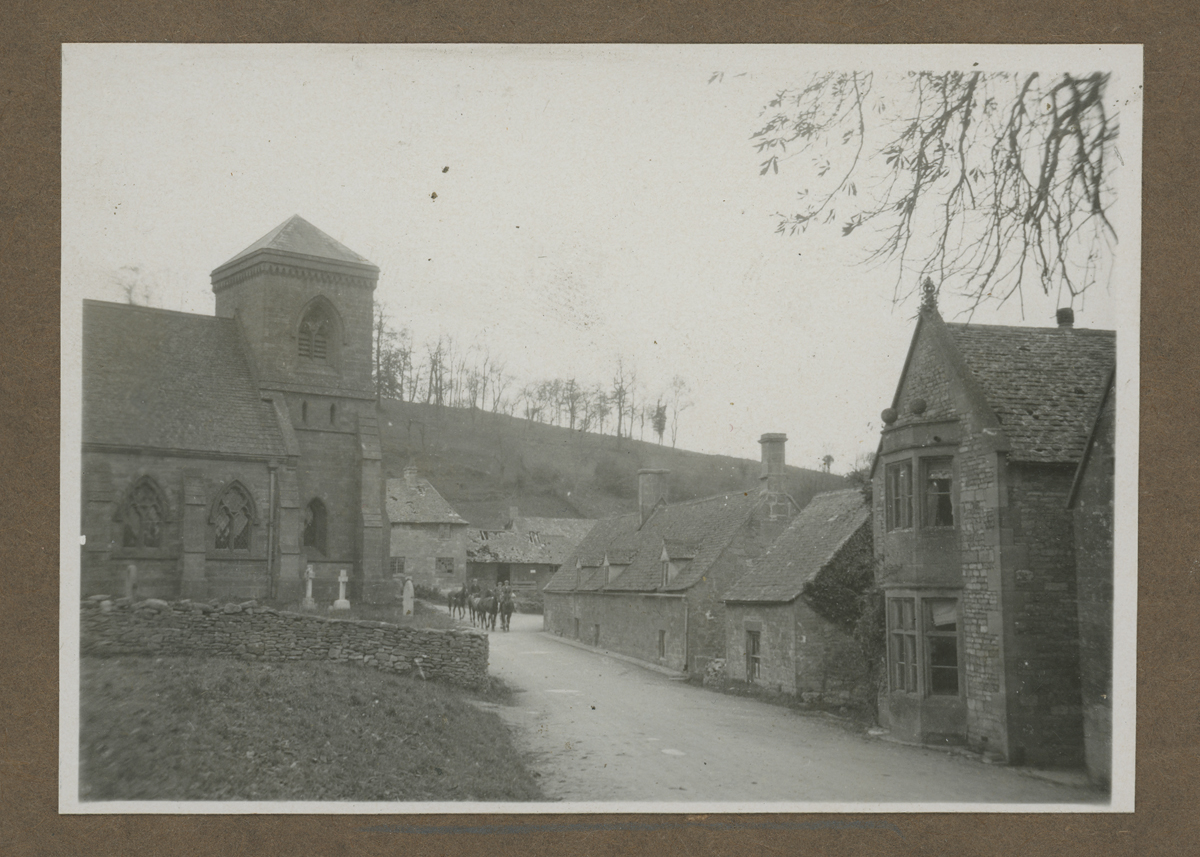 Road running between stone buildings with stone walls