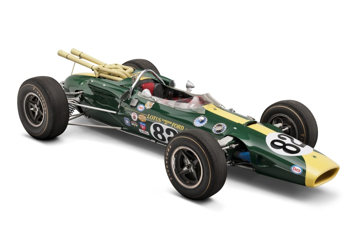 1965 Lotus-Ford Race Car Long, low, torpedo-shaped green and yellow race car with large tires and open cockpit