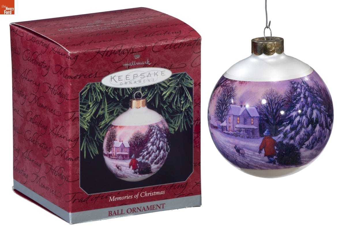 Hallmark "Memories of Christmas" Christmas Ornament, 1998 White bulb ornament with image of person dragging Christmas tree across a snowy field toward a house; box for ornament is also in photo