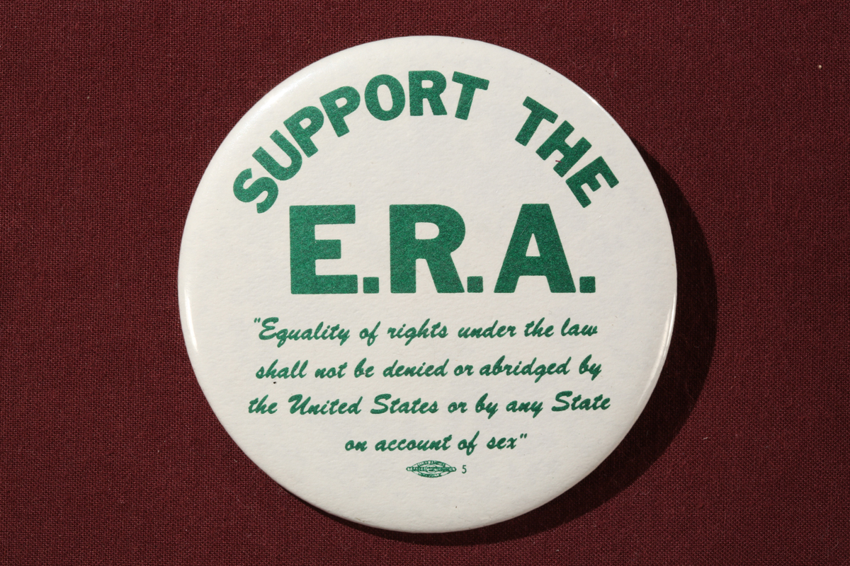 THF153507 Round white button with green block text reading in part “Support the E.R.A."