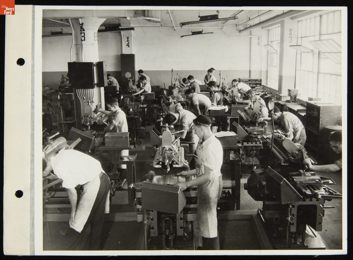 Students at Henry Ford Trade School, July 31, 1935 Group of boys and young men work at machines in crowded room