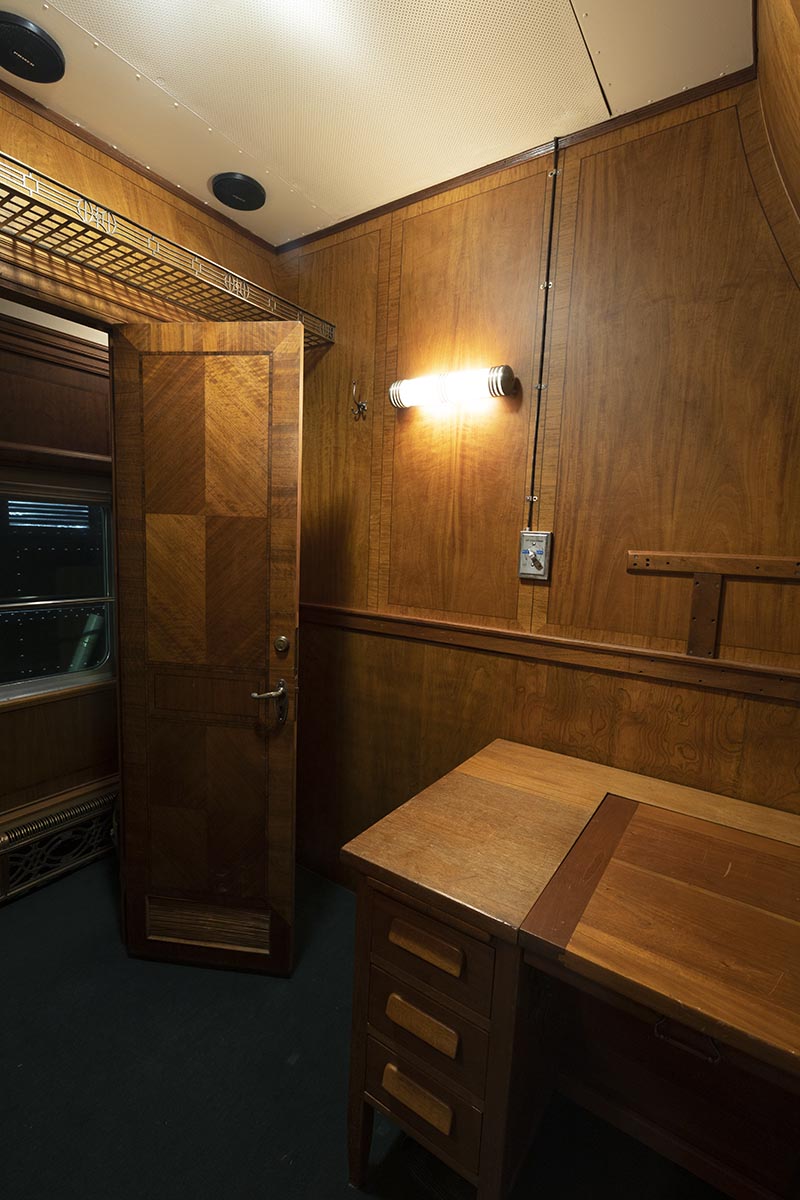 Fair Lane railroad car office Interior of wood-paneled room containing a wooden desk