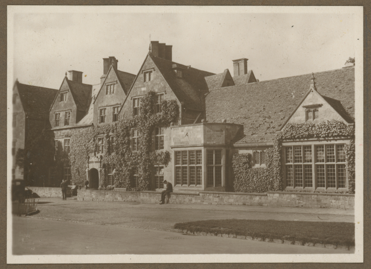 Ivy-covered stone building; road in front