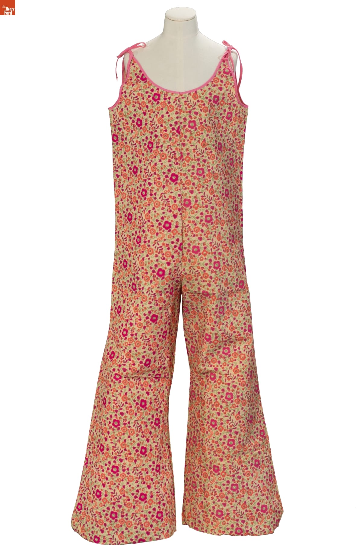 Paper Jumpsuit, 1966-1968 Sleeveless jumpsuit in green, red, and orange floral pattern with ties at the shoulders