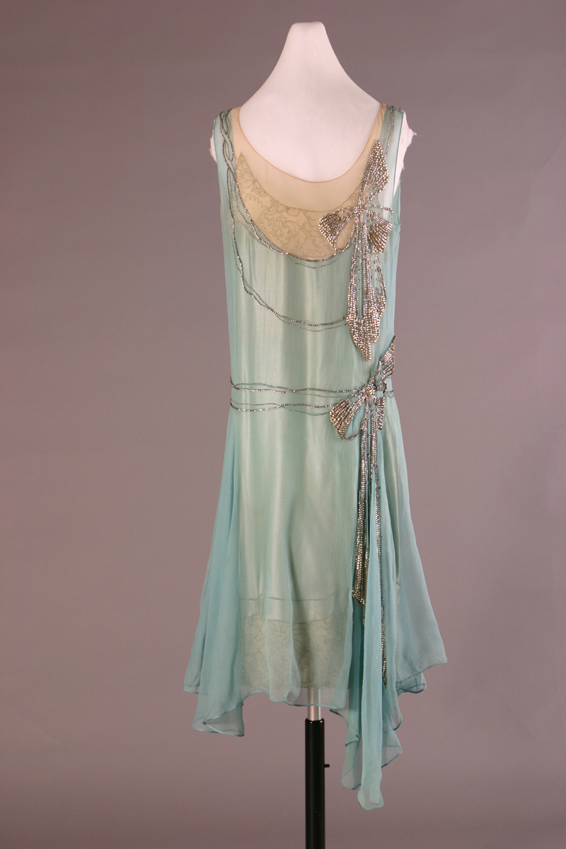 Evening Dress, Made by Peggy Hoyt for Elizabeth Parke Firestone, 1928 Pale blue and beige dress with beaded bow detailing