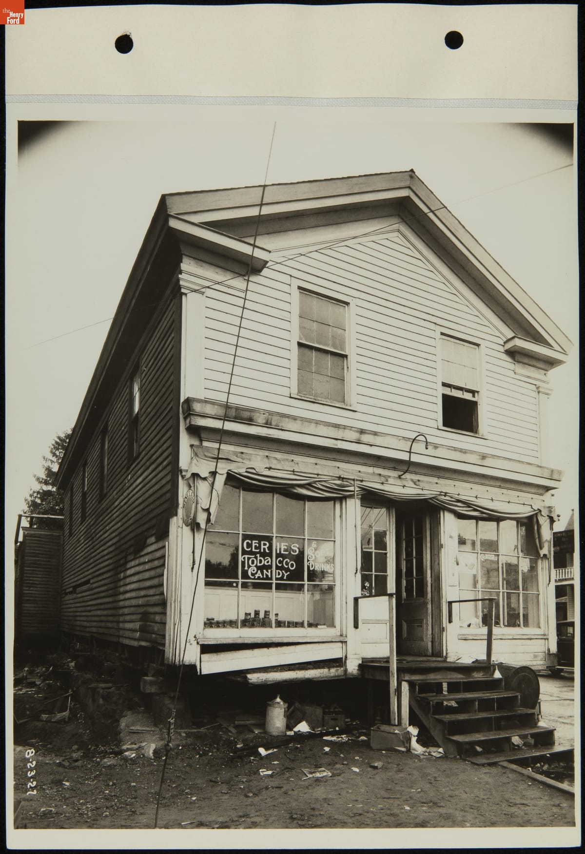 Black-and-white photo of two-story wooden building