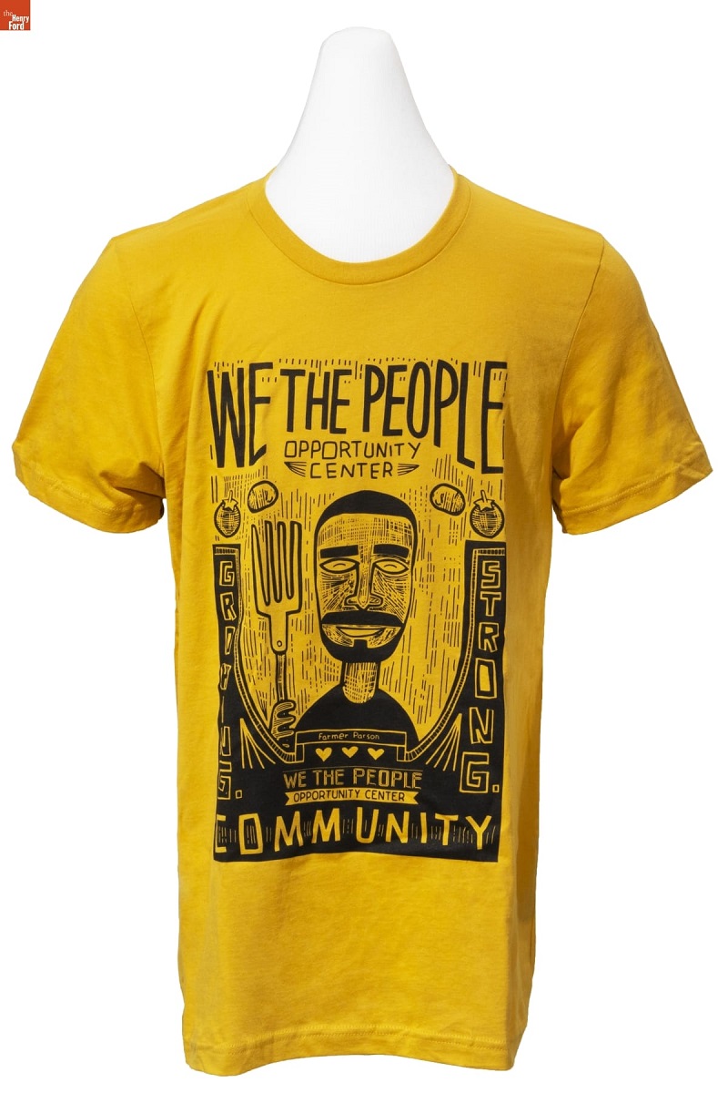 Yellow t-shirt with black caricature drawing of a man with large fork along with text and images