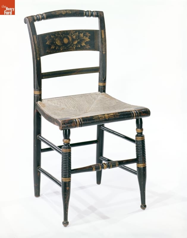 Black wooden chair, with woven seat, painted with gold decoration