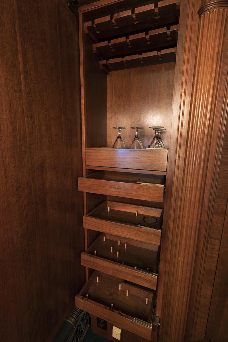 Henry Ford's Private Railroad Car "Fair Lane," 1921 / glassware storage Wooden shelving with pegs on some shelves and a few glasses on top shelf