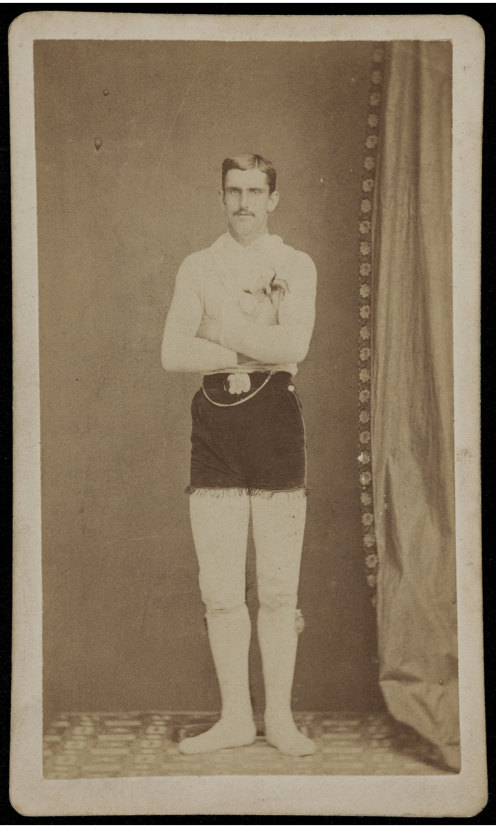 GIF cycling through four black-and-white photos of men standing with arms crossed, wearing white long-sleeved shirt, white tights (?), and dark velvet shorts with fringe