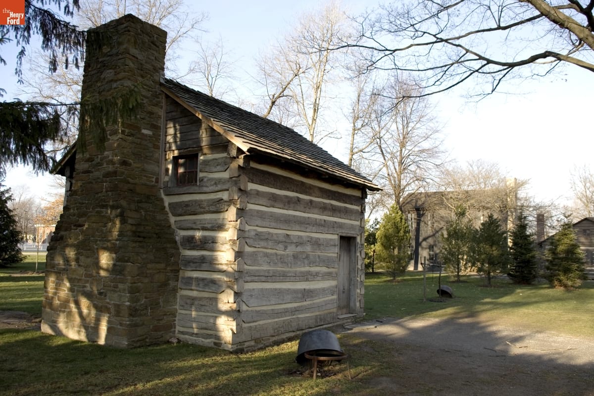 McGuffey Birthplace in Greenfield Village, September 2007 / Photographed by Michelle Andonian Log cabin with stone fireplace among trees with another building visible in the background