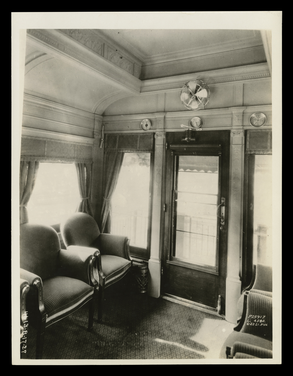 Interior of Henry Ford's Private Railroad Car, "Fair Lane," June 22, 1921 Black-and-white photo of room showing two chairs, windows, and glass door