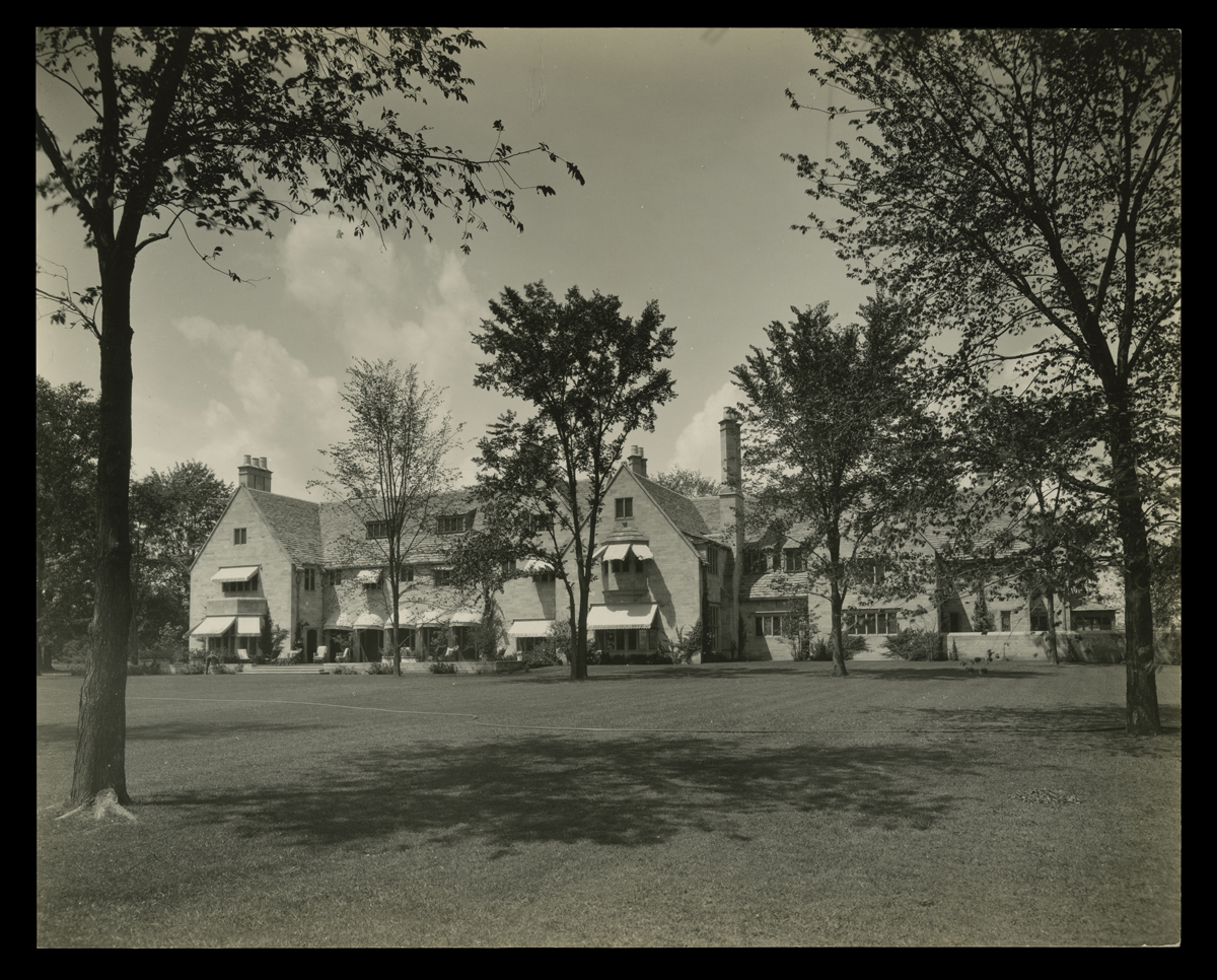 Large building, seen across lawn containing trees