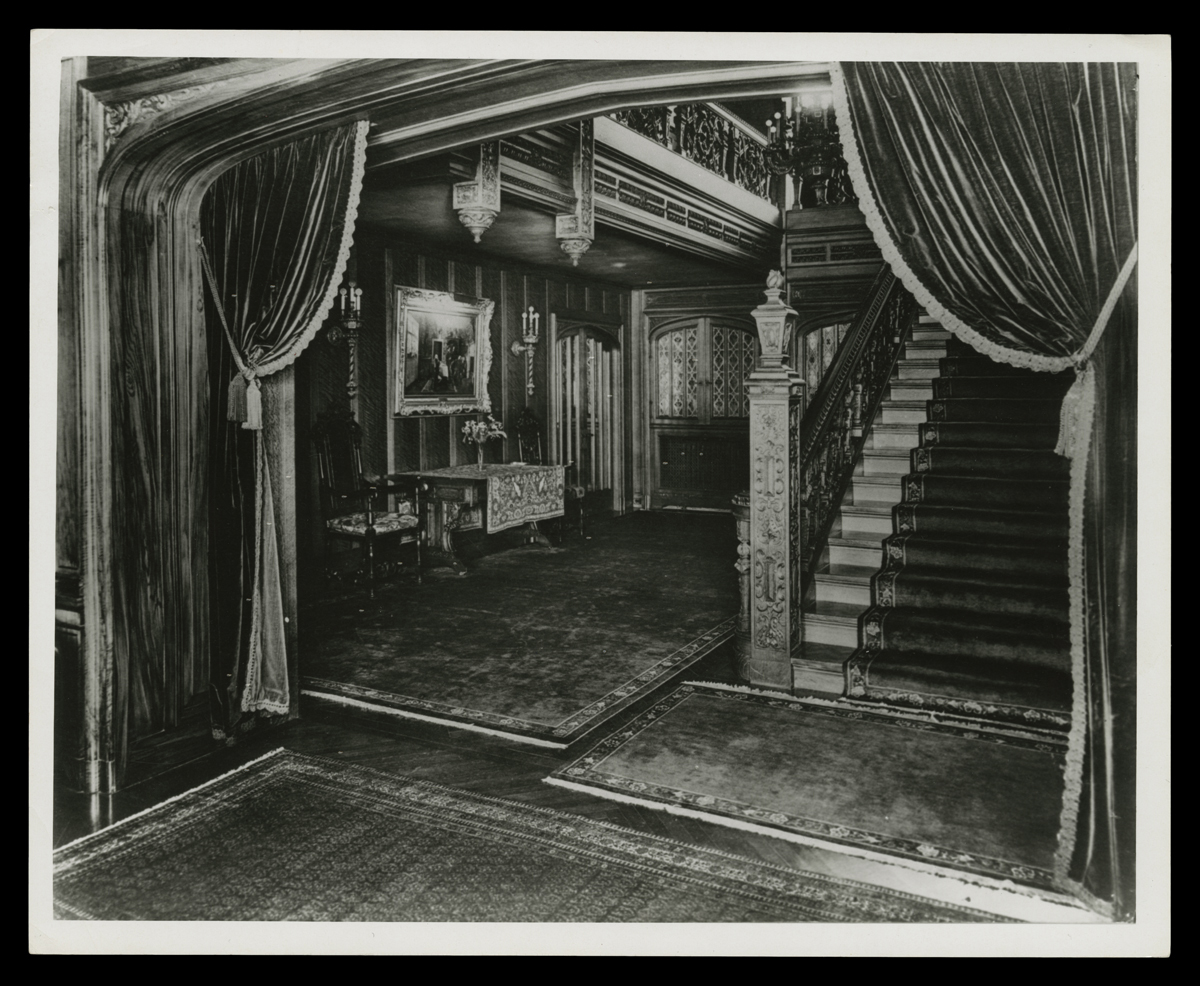 Staircase and Entrance Hall inside Fair Lane, Home of Henry Ford, circa 1925 Interior of house with carved wood, heavy draperies, and staircase
