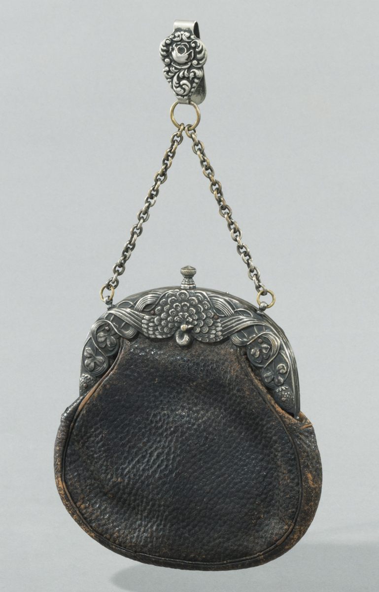 Handbag, circa 1900 Brown pebbled leather handbag with elaborate silver clasp with a peacock in the center and a silver chain