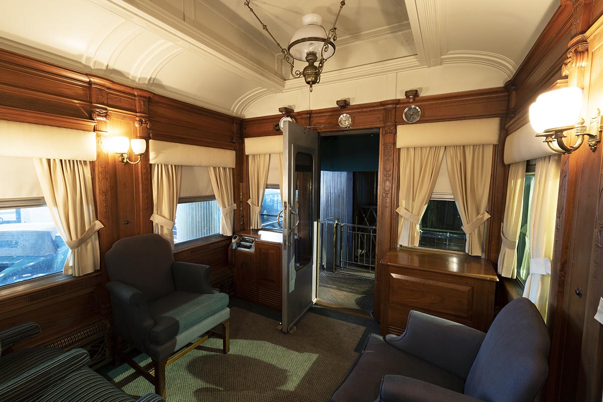 Henry Ford's Private Railroad Car "Fair Lane," 1921 / observation saloon Room interior with arched ceiling, blue upholstered furniture, and wood paneling
