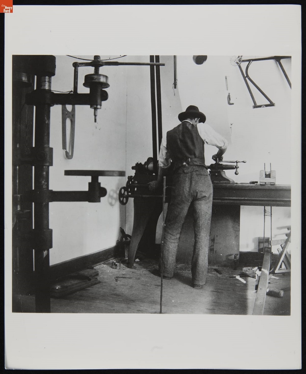 Man Working at a Lathe in the Wright Cycle Shop, Dayton, Ohio, 1897 Back view of man working at a table in what appears to be a workshop