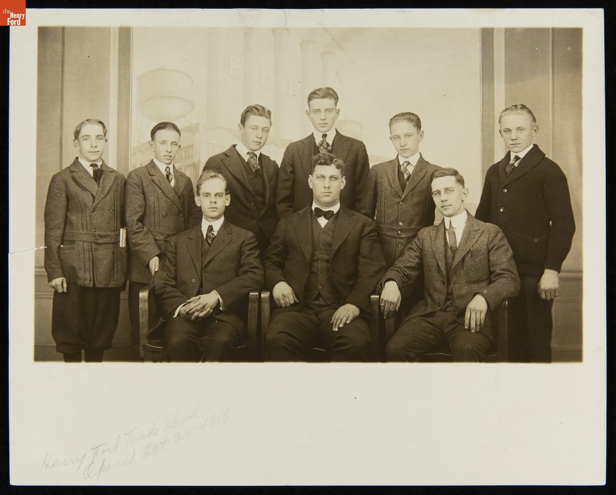 Henry Ford Trade School Students and Instructors on the School's Opening Day, October 25, 1916 Group of nine sitting and standing boys and men, all wearing suits, pose for a photo