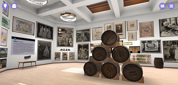 A screenshot from The Henry Ford's entrepreneurship Sagan Virtual room with wooden floor and white walls covered with images; stacked barrels in the center of the room