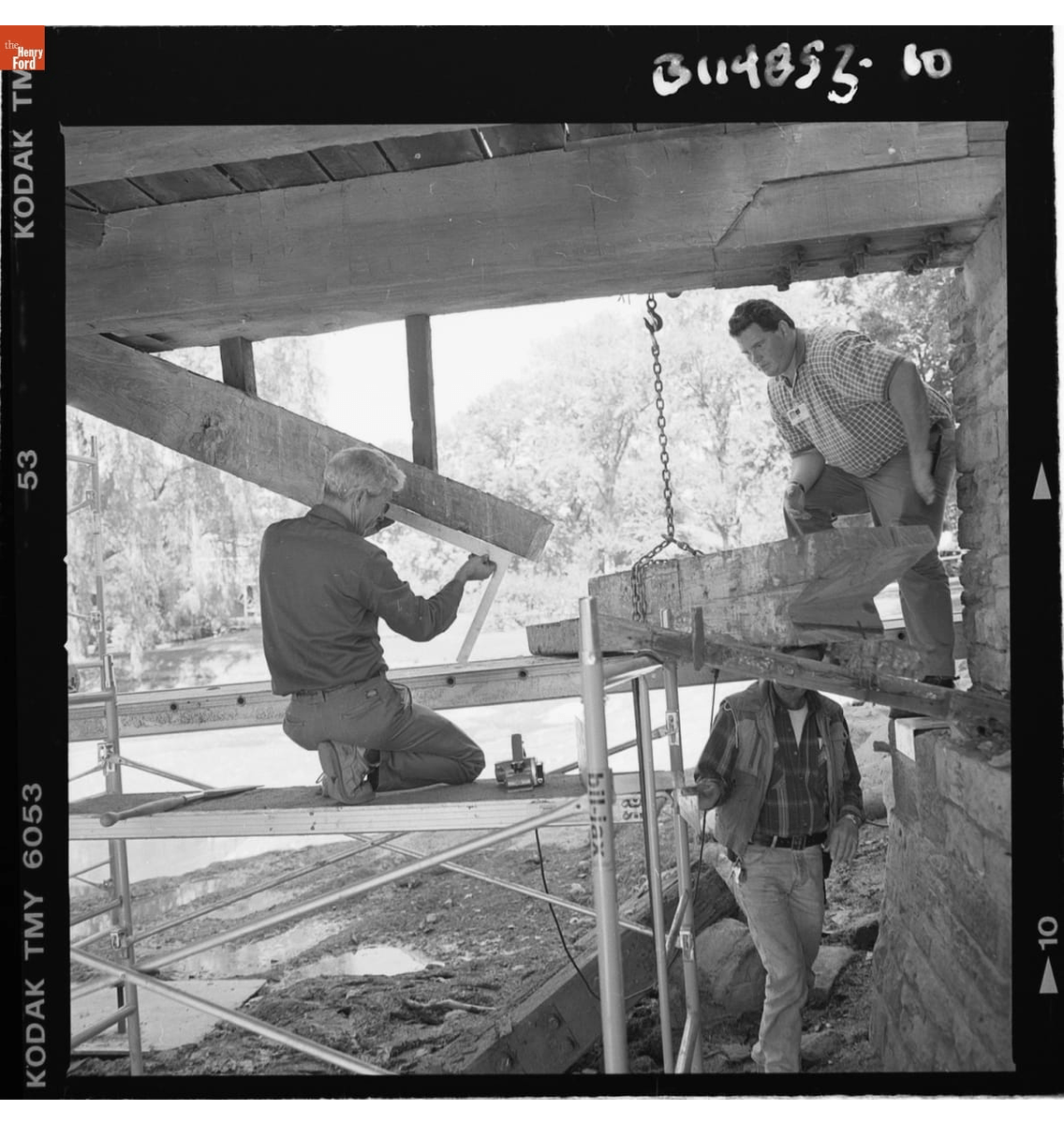 Restoration Work on the Ackley Covered Bridge in Greenfield Village, September-October 2000 GIF slowly cycling through three black-and-white images of construction work on a wooden structure