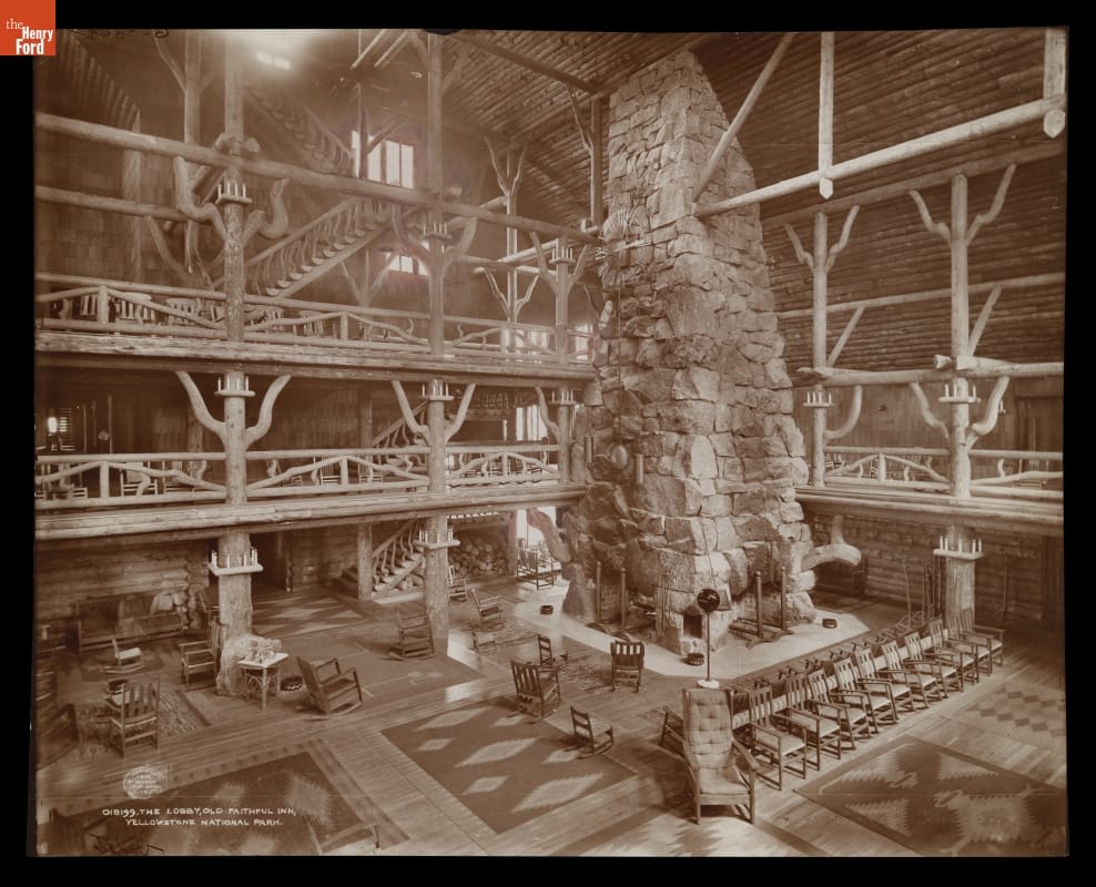 The Lobby, Old Faithful Inn, Yellowstone National Park, 1905 Rustic building lobby with several levels with walkways around the perimeter and a multiple-story stone fireplace