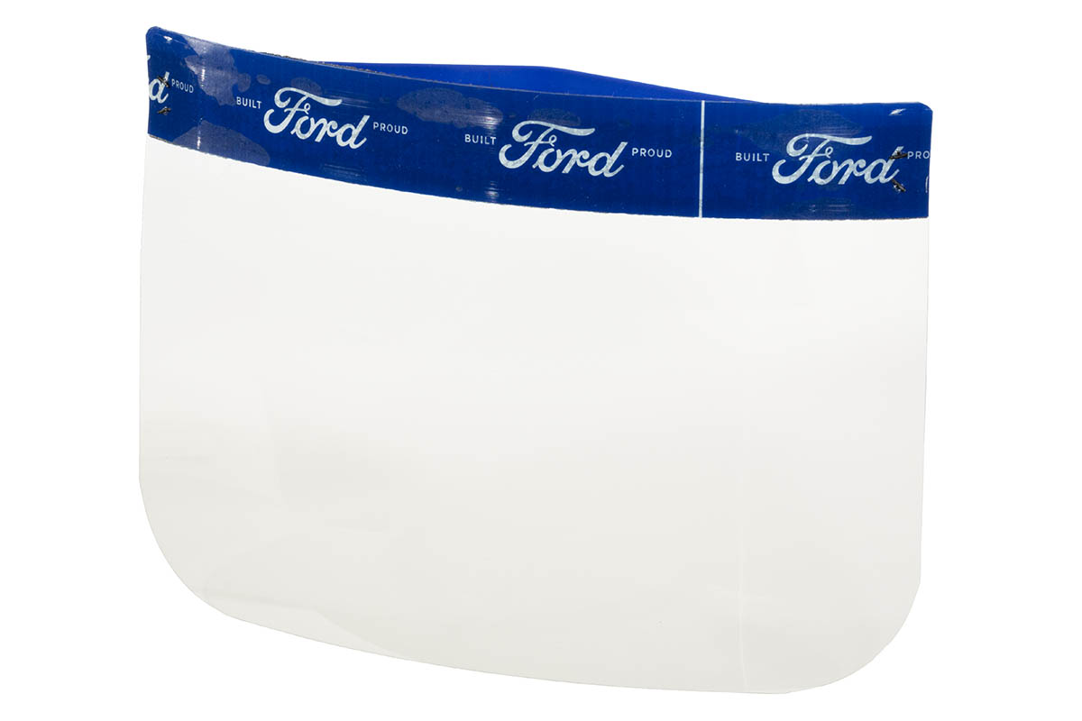 Face Shield, 2020 Clear plastic rectangle with rounded corners, topped with blue band patterned with white text "Built Ford Proud"