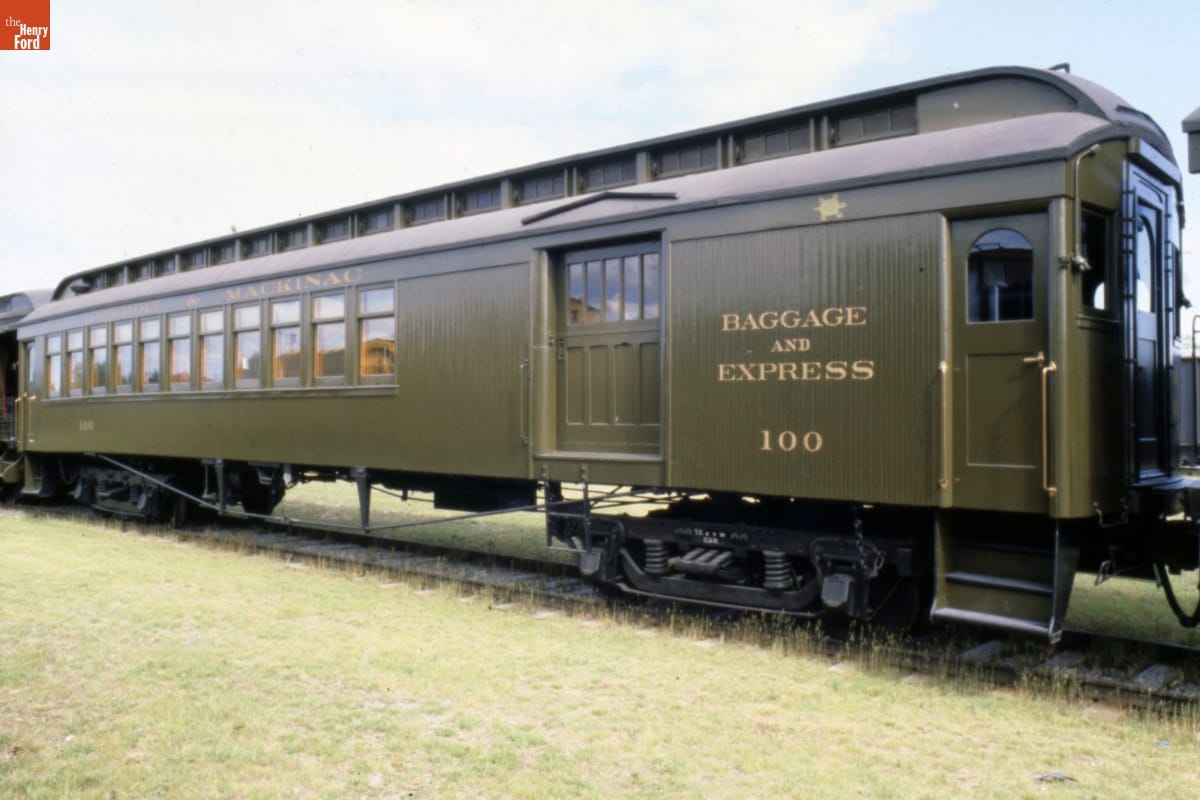 Detroit & Mackinac Railway Combination Car, 1901-1905 Army green railroad car on railroad tracks