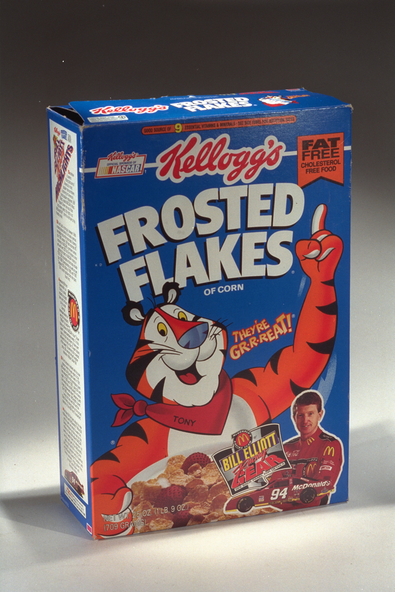 Kellogg's Frosted Flakes Breakfast Cereal, 1994-1996 Blue Kellogg's Frosted Flakes Breakfast Cereal box, 1994-1996, with orange-and-white “Tony the Tiger” and picture of racer Bill Elliott