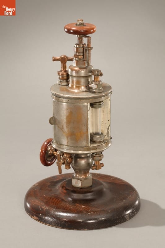 Steam Engine Lubricator, 1882 Brass machine with various knobs and fittings