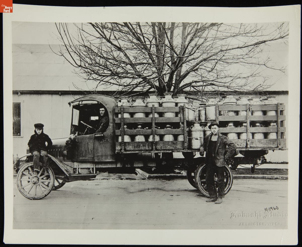 Two Men and a Boy Pose with a Mack Model AB Stake Truck Loaded with Milk Cans, 1920