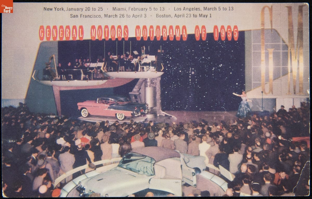 General Motors Motorama of 1955 Pink and gray car on platform under another platform with musicians; a crowd of people and another car on a platform in the foreground; contains text
