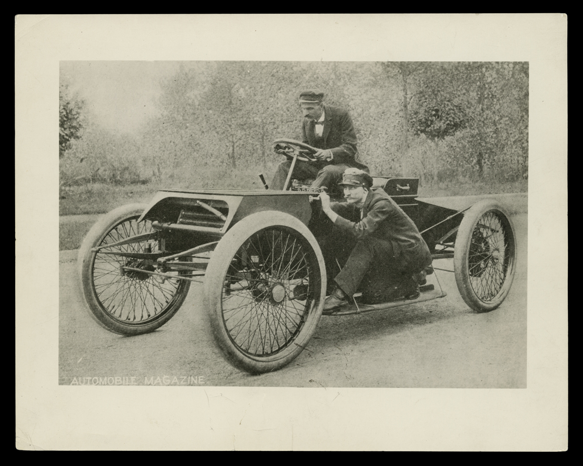Henry Ford and Spider Huff with the Sweepstakes Racer on a Detroit, Michigan, Street, 1901 Early open automobile on street with one man behind wheel and another crouching on running board