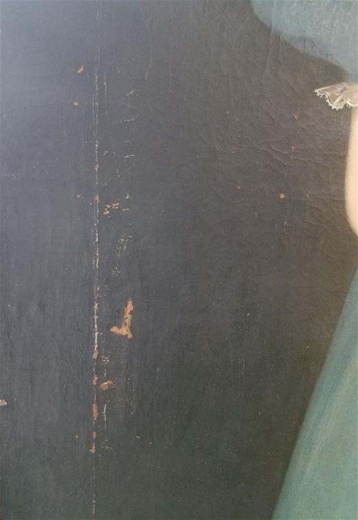 Before adding fills to the areas of paint loss Close up of black paint showing brown chips