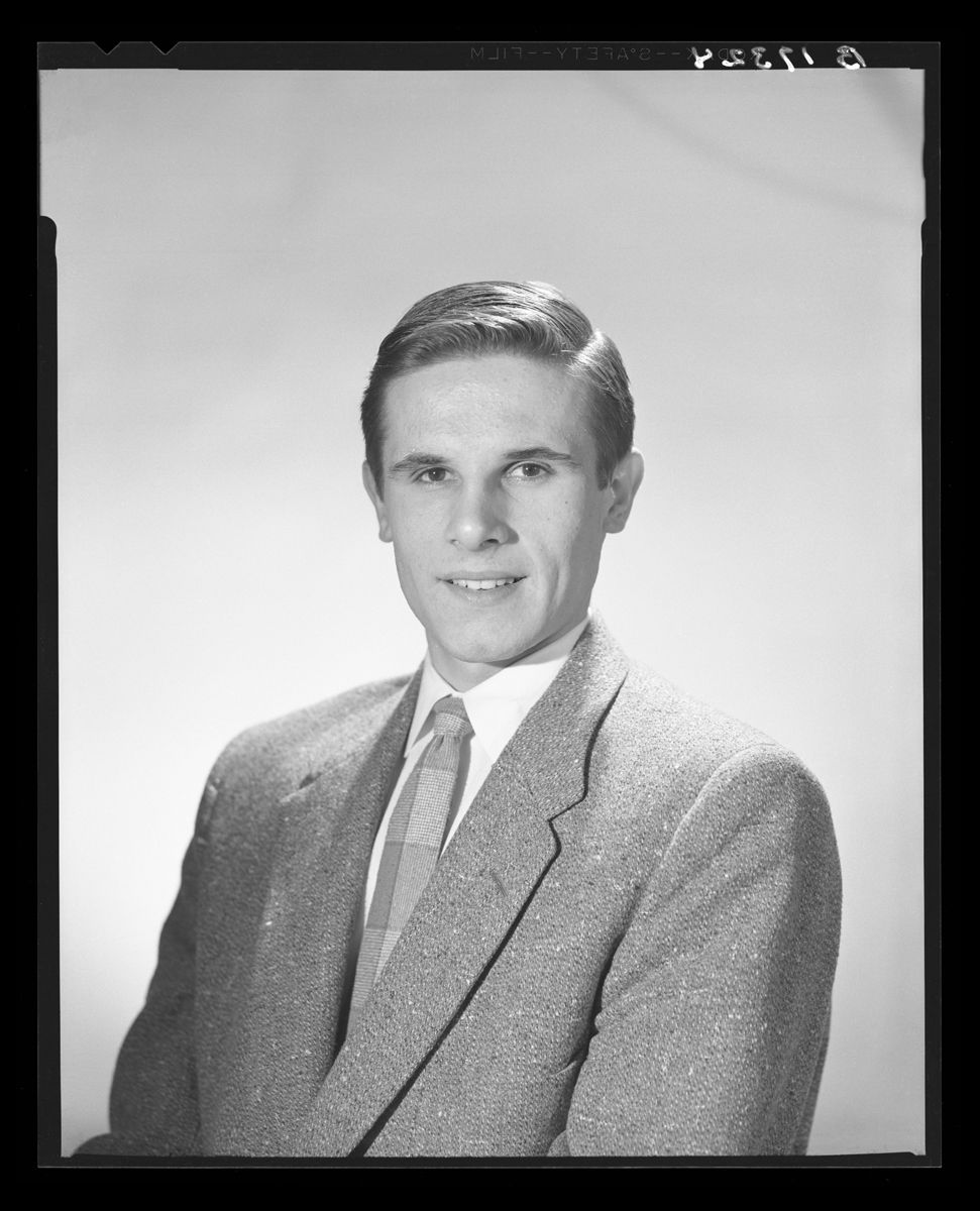 Portrait of Rudy Ruzicska, 1957 Black-and-white posed portrait photograph of young man in suit