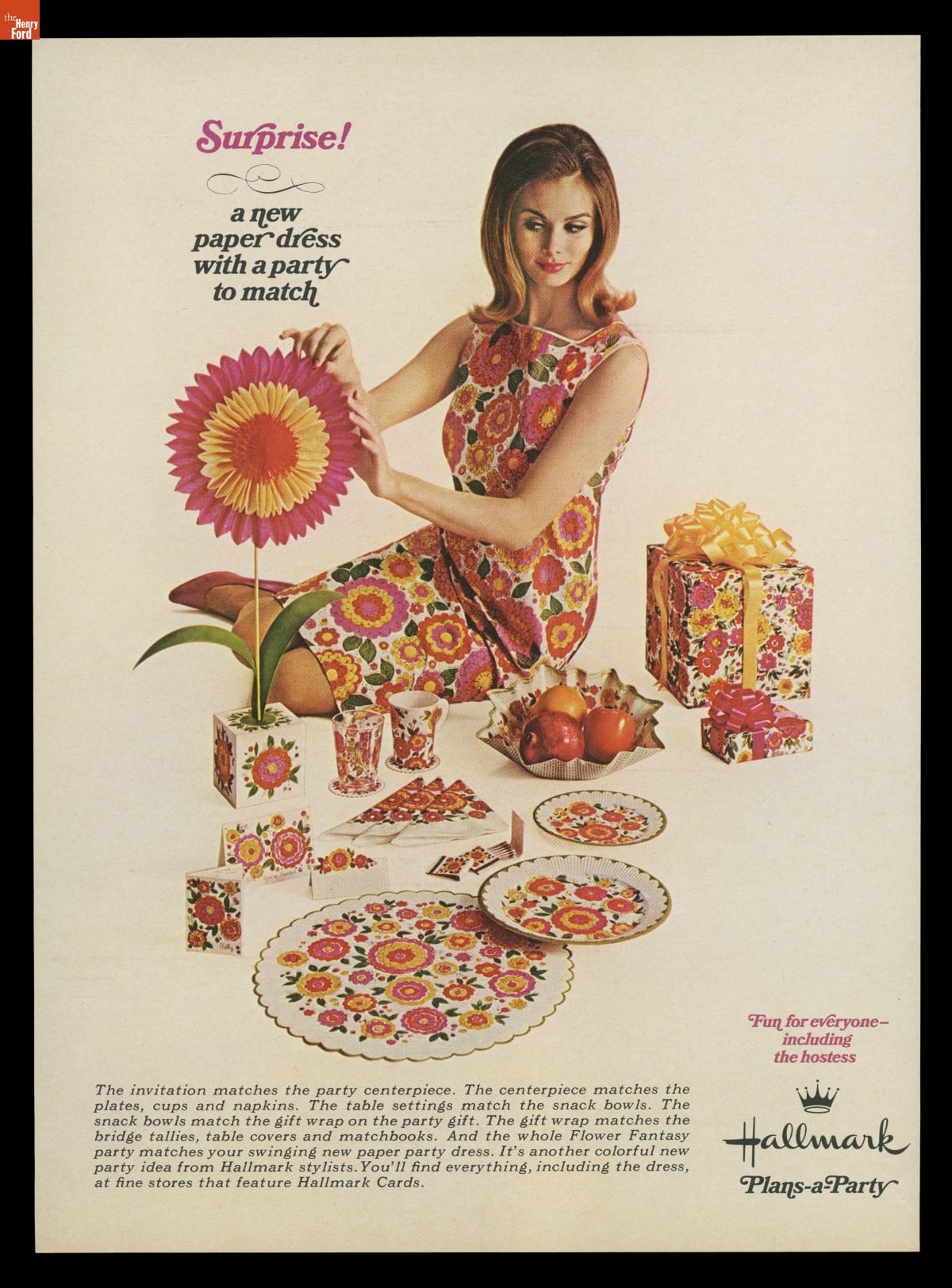 Surprise! A New Paper Dress with a Party to Match, 1967 Seated woman wearing floral dress with matching floral tableware, decorative honeycomb paper flower and wrapped gift nearby