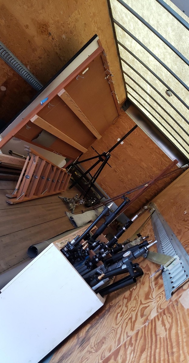 Angled image of wooden interior of truck containing furnishings and equipment