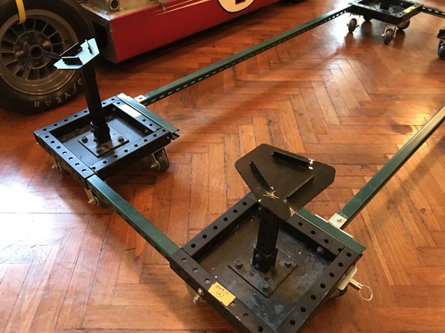 Custom dolly, or "rolling jackstand." Metal frame on casters with widgets at each corner