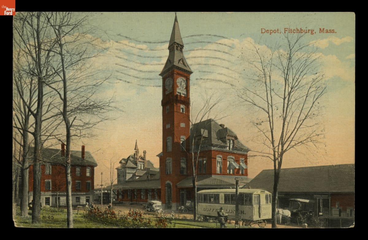 Lunch Wagon by the Railroad Depot, Fitchburg, Massachusetts, circa 1916 Color postcard of red brick buildings, one with tall clocktower, with cars, wagon, and green space in front