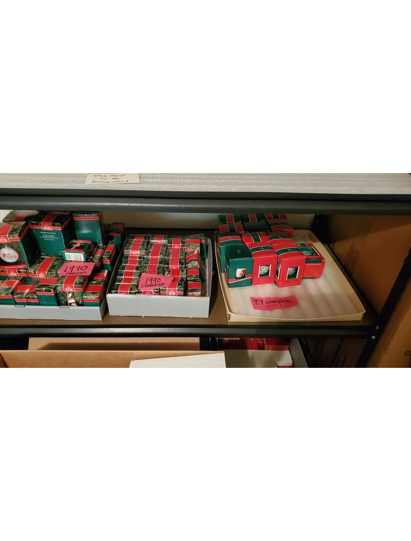 Photographed ornaments being sorted before being boxed up for storage. GIF cycling through three images of small red and green boxes in larger gray boxes