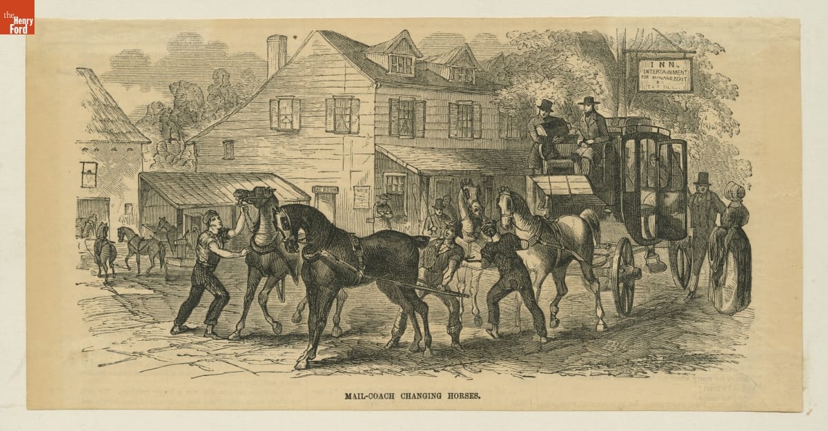 Mail Coaches Changing Horses at a New England Tavern, 1855 Engraving of men holding the harnesses of horses in front of a carriage, with buildings in the background and other horses and people around