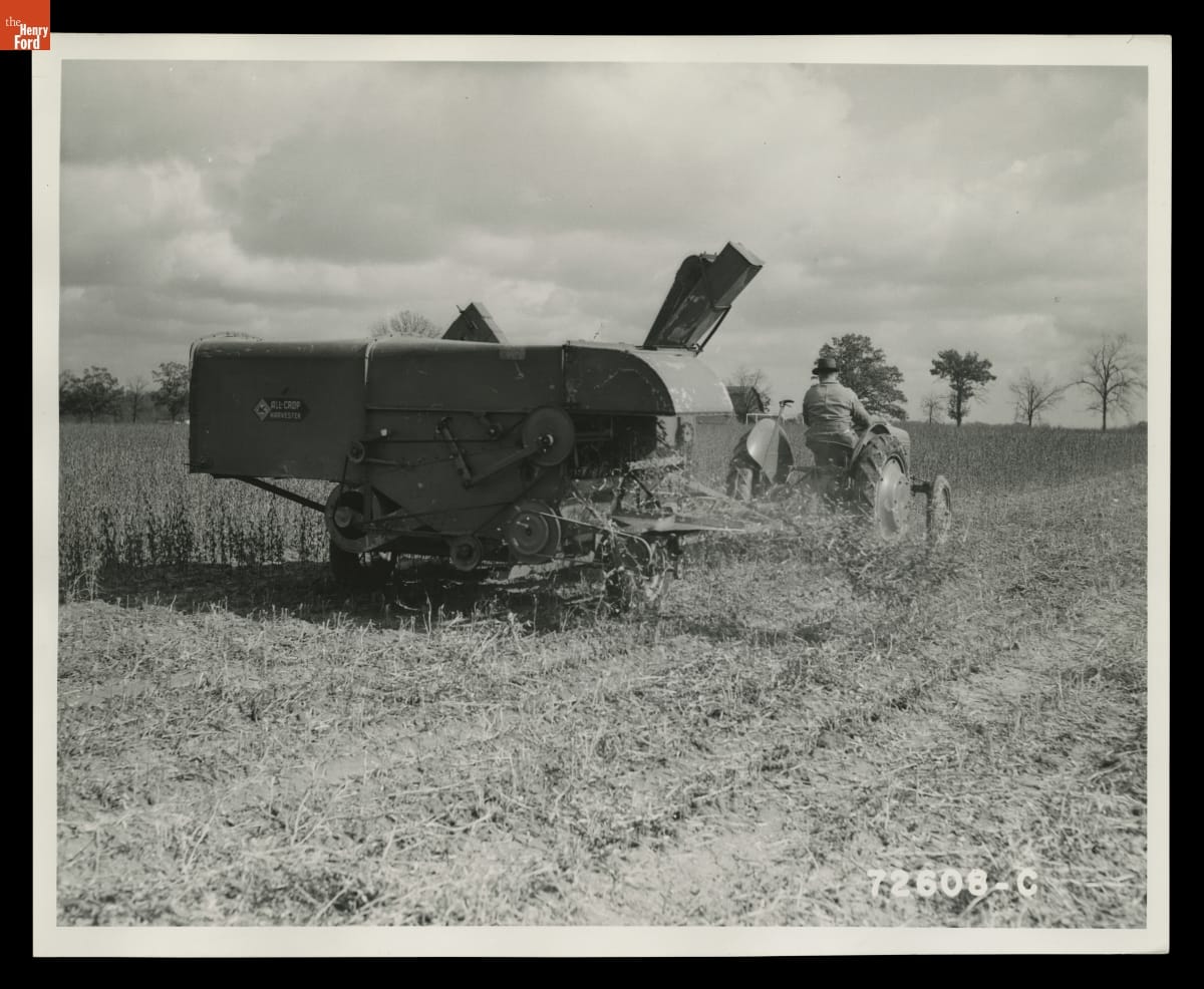 Ford-Ferguson Model 9N Tractor Pulling a Combine, Macon, Michigan, November 1939 Black-and-white photo of person on tractor pulling a piece of agricultural equipment behind them through a field