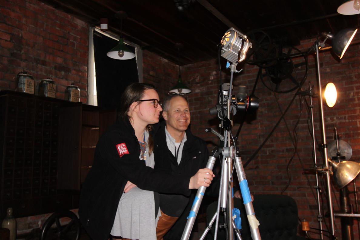 Another example of getting creative to photograph a lathe used by Henry Ford out at the Bagley Avenue Workshop in Greenfield Village Two people behind a camera on a tripod in a brick-walled room