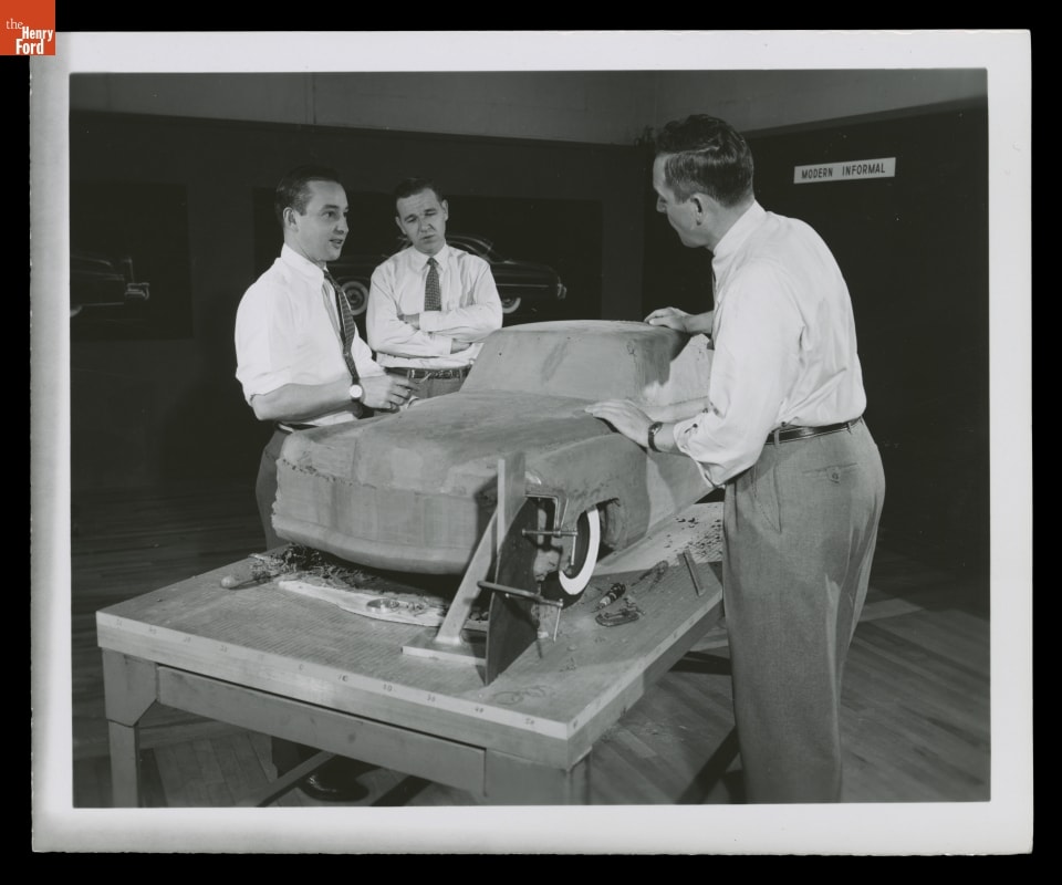 William Clay Ford (at left) with Harley Copp and John Reinhart, and Continental Mark II Model, February, 1953 Three men standing around clay model of car on table