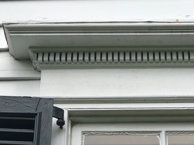 Decorative window lentil, ornamented with dentils, on the Noah Webster Home Close-up of decorative trim above a window