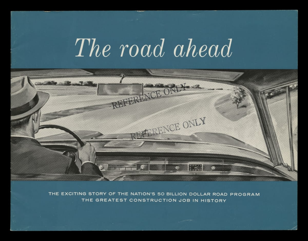 Blue page with text and image of road visible through car dashboard as man in suit and hat drives