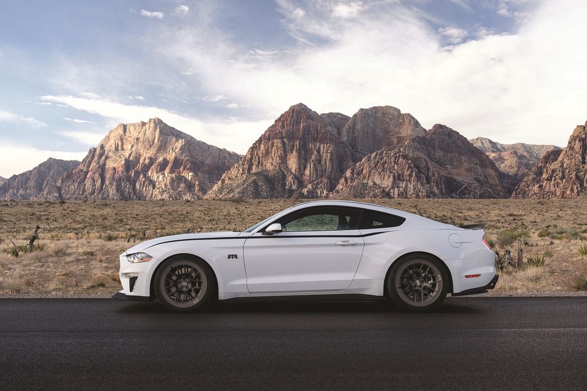 Vaughn Gittin Jr.’s 2019 Mustang RTR Spec 3 Side view of sleek white car parked on road in front of desert and mountains