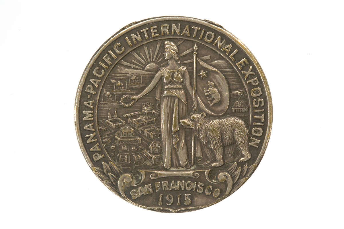 Round medallion with text and image of a woman holding a flag, a bear, and buildings