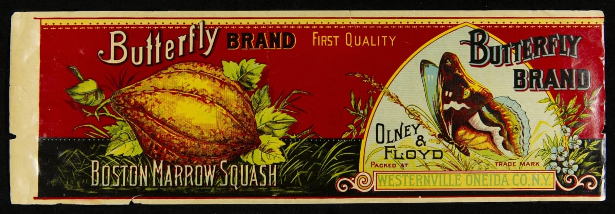 Red can label with image of butterfly and bulbous yellow squash; also contains text