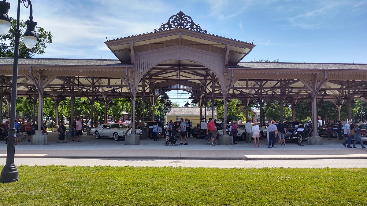 Lincoln Continentals at Detroit Central Market during Motor Muster 2022 Large low building with open sides, filled with cars and spectators